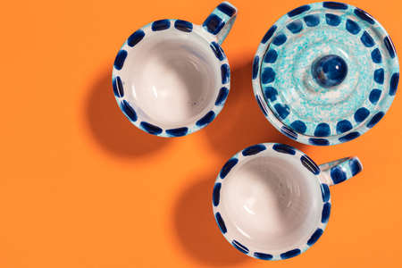 flat lay of blue small coffee cups and sugar bowl on a wooden elegant background, coffee shop or home kitchenの写真素材
