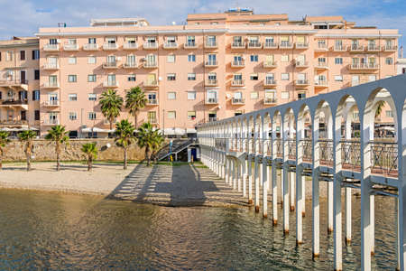 Pirgo beach in the center of Civitavecchia between the Promenade from Largo Caprera and the Borgo Odescalchi. View from the platform of the Pirgo along its pedestrian bridgeの写真素材