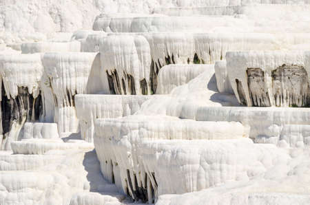 Stalactites of Pamukkale's terraces, made of travertine, a sedimentary rock deposited by water from the hot springs.の写真素材