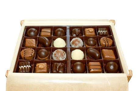 Chocolates in a wooden box isolatedの写真素材