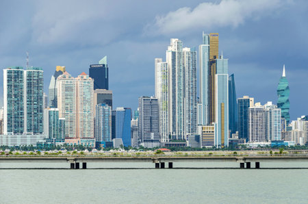 Panama City, Panama - November 3, 2017: Skyline of Panama City on a cloudy day with modern buildings, the F&F Tower, Tower Bank and Bicsa Financial Center with its distinctive glass color (gold). View from Cinta Costeraのeditorial素材