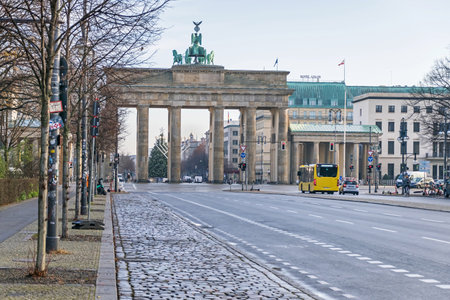 Berlin, Germany - December 18, 2020: Platz des 18. Maerz (18 of March Square) with the Brandenburg Gate, Hanukkah candlestick and decorated Christmas tree in the backgroundのeditorial素材