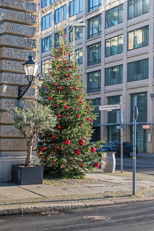 Berlin, Germany - December 18, 2020: Christmas tree decorated with red balls at the street Behrenstrasse corner Charlottenstrasseのeditorial素材