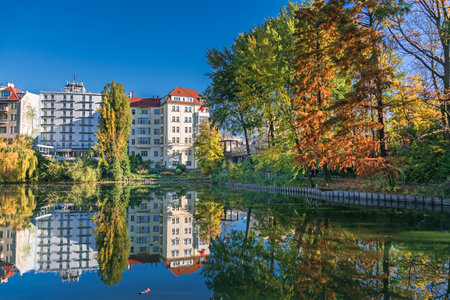 Berlin, Germany - November 7, 2020: Shore of Lake Lietzen with buildings of Ringhotel Seehof reflecting in the water and the Lake Lietzen bridge over the street Neue Kantstrasseのeditorial素材