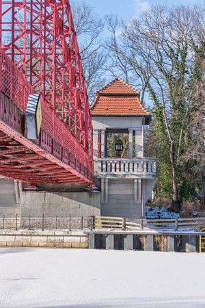 Berlin, Germany - February 12, 2021: Heritage-protected steel truss Haven bridge (Sechserbruecke) over the frozen stream Tegeler Fliess with its pavilion-like gate and one of two ticket boothsのeditorial素材
