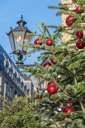 Berlin, Germany - December 18, 2020: Christmas tree decorated with red balls at the street Behrenstrasseのeditorial素材