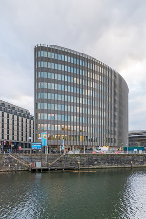 Berlin, Germany - November 16, 2020: Bank of the river Spree Reichstagufer with the landing pier for boats Friedrichstrasse and the office building Spreedreieck; view from the bank Schiffbauerdammのeditorial素材
