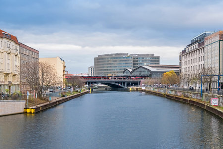 Berlin, Germany - November 16, 2020: Bank of the river Spree Reichstagufer with the railway bridge, train station Friedrichstrasse and the office building Spreedreieck; view from the Marshal Bridgeのeditorial素材
