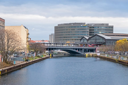 Berlin, Germany - November 16, 2020: Bank of the river Spree Reichstagufer with the railway bridge, train station Friedrichstrasse and the office building Spreedreieck; view from the Marshal Bridgeのeditorial素材