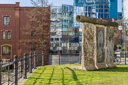 Berlin, Germany - February 14, 2019: Newly designed area Spree-Bogen at the Banks of the river Spree with the building of the Ernst-Freiberger foundation and a part of the Berlin Wallのeditorial素材