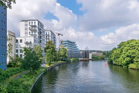 Berlin, Germany - July 3, 2021: Bank of the river Spree Schleswiger Ufer with recently erected buildings and the tower of the Fraunhofer Institute for Telecommunications in backgroundのeditorial素材