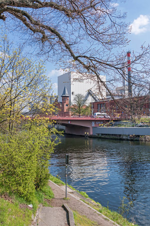 Berlin, Germany - April 20, 2021: Berlin-Spandau shipping canal with the Foehrer bridge and Combined heat and power plant Moabit with its historical built in 1900 lists buildingのeditorial素材