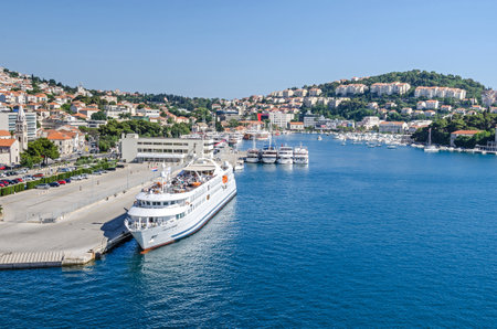 Dubrovnik, Croatia - June 9, 2017: Seaport of Dubrovnik at a sunset with the passenger terminal and ferry boats, a part of the street Obala Stjepana Radicaのeditorial素材
