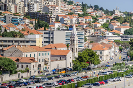 Dubrovnik, Croatia - June 9, 2017: Modern part of Dubrovnik, rebuild and renewed after the war and the break-up of Yugoslavia, part of the street Obala Stjepana Radica at the seaport with a church and apartment hotelsのeditorial素材
