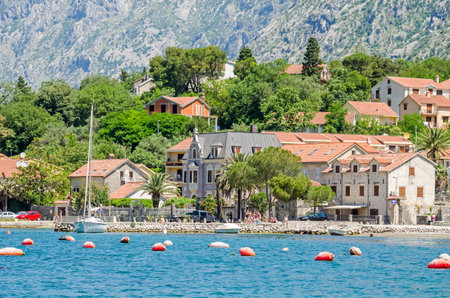 Kotor, Montenegro - June 8, 2017: Dobrota coast of the Bay of Kotor. A part of the waterfront, that consists of a long line of stone villas and a small beach.のeditorial素材