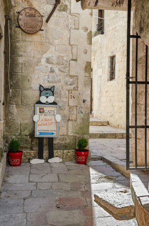 Kotor, Montenegro - June 8, 2017: A typical view in one of the narrow streets in a very tourists friendly old town of Kotor with a shop sign of a cat.のeditorial素材