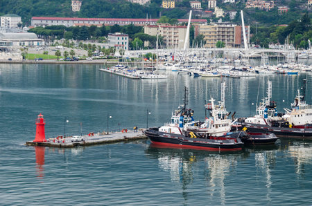 La Spezia, Italy - May 29, 2016: View of the city La Spezia, the chief Italian naval station and arsenal, from the sea, showing marina with pilot boats and Thaon Revel City Bridgeのeditorial素材