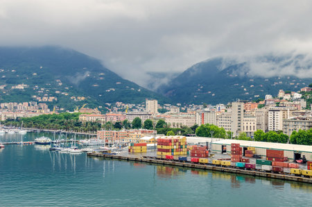 La Spezia, Italy - May 29, 2016: A general view of the city of La Spezia, the chief Italian naval station and arsenal, from the sea, showing containers of the city's port, marina and palm-lined water front Morin by rainy weatherのeditorial素材