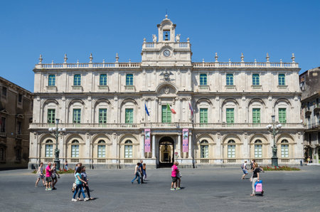 Catania, Italy - July 3, 2017: Historical building of the University, the oldest university in Sicily, with many people walking through the place. Its academic nickname Siculorum Gymnasium is to be seen over the entrance.のeditorial素材