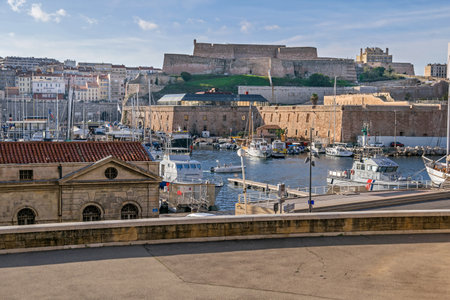 Marseille, France - November 1, 2019: View from the Vaudoyer Sreet at the Old Port with all kinds of boats and Fort Saint-Nicolas built on Louis XIV's ordersのeditorial素材