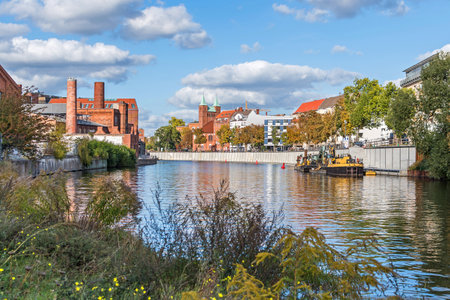 Berlin, Germany - October 9, 2022: River Spree with the Gebauer Hoefe, a listed ensemble of historical factory buildings, and Wikinger Ufer with the Protestant Church of the Redeemerのeditorial素材