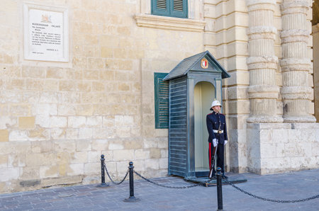 Valletta, Malta - November 8, 2015: Armed guard in uniform posted at the entrance of Buckingham Palace in Valletta.のeditorial素材