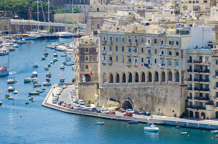 Senglea, Malta - June 4, 2017:  Senglea waterfront as seen from the Grand Harbour, its modern part with limestone buildings adapted to the old maltese architectural styleのeditorial素材