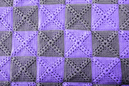 Knitted handmade colourful blankets ultra violet colors. Colorful original knitted handmade work. Crochet stitches. Rustic backgroundの写真素材