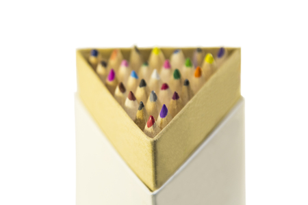 Color pencils in a triangular close-up, stationery, office and school supplies, isolated on a white background with a soft blurred focus.の写真素材