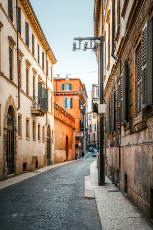 Cobbled streets on old stoned street in the beautiful evening sunset in Verona, Italyの写真素材