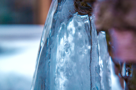 Winter waterfall in spring, close-up. Frozen water.の写真素材