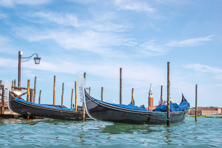 Gondolas in Venice and St Mark's Basin with San Giorgio Maggiore and Giudecca island in the backgroundの写真素材