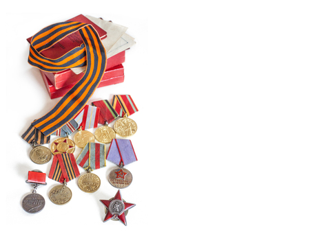 Concept May 9, victory USSR in the Second World War - Order of the Red Star, medals for liberation of Berlin, Warsaw, for valor and merit and St. Petersburg. George's ribbon, on white background, with place for textの写真素材