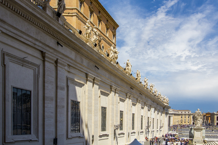 View of St. Peter's Square with semicircular colonnade with statues (Piazza Obliqua) and St. Peter's Basilica in Vatican City, tourists look at attractions, Rome, Italyのeditorial素材