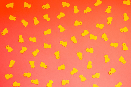 Yellow chickens on a red orange background, Happy Easter concept, abstract pattern.