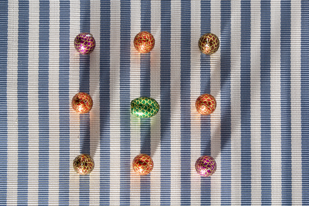 Colorful sweets candy on striped background. Chocolate dessert eggs - Happy Easter tradition.の写真素材