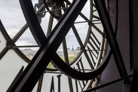 PARIS, FRANCE - MAY 9, 2019: Famous clock with roman numerals  (round window) in Orsay Museum,...