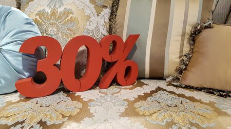 Red colors 30% discount promotion sale percent on tapestry sofa with blue pillow in store, offer...