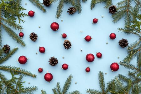 Christmas or new year winter composition. Red toys, spruce fir branches, pine cones, decorative...