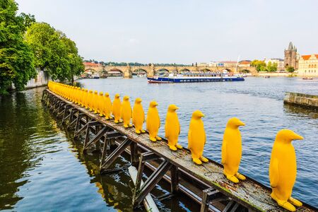 PRAGUE, CZECH REPUBLIC - 24 AUGUST, 2019: Yellow Penguins in row at Kampa park - installation to send message about the dangers of climate change, Prague, Czech Republicのeditorial素材