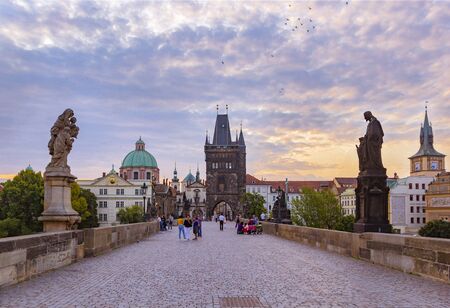 PRAGUE, CZECH REPUBLIC - 26 AUGUST, 2019: Charles Bridge, Old Town Tower and statues at sunrise, Prague, Czech Republicのeditorial素材