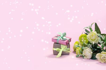 Bouquet of flowers and gift boxes on pink background. Concept Valentine's day, mother's holiday, wedding or March 8 greeting cardの写真素材