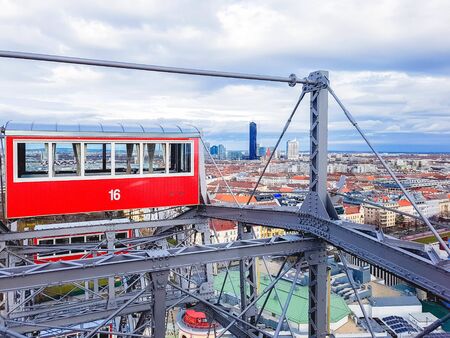 Panoramic view of Vienna and red retro cab from height ferris wheel in Prater Amusement Park, Vienna, Austriaの写真素材