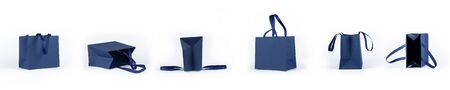 Banner from empty gift paper bags, shopping bag in classic blue color isolated on white background. Mockup of blank craft package. Concept for presents holidays.の写真素材