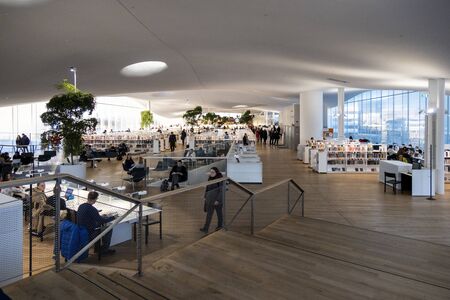 HELSINKI, FINLAND - JANUARY 05, 2020: Helsinki Central Library Oodi and living meeting place with range of services in modern design in city center. Interior inside building with glass windows, wooden facadeのeditorial素材