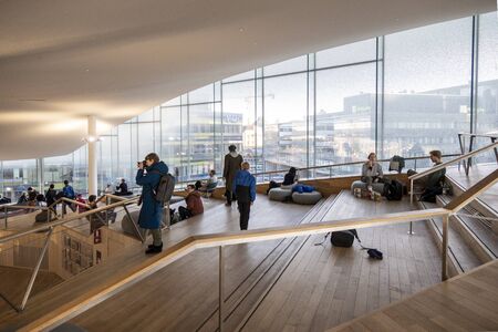 HELSINKI, FINLAND - JANUARY 05, 2020: Helsinki Central Library Oodi, living meeting place with range of services in modern design in city center. Interior inside with glass windows, wooden facadeのeditorial素材