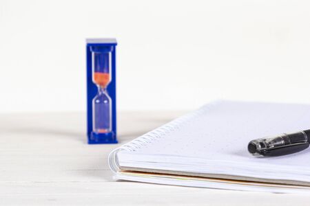 Notebook with pen, hourglass - great design for any purposes. Time management, creative business....