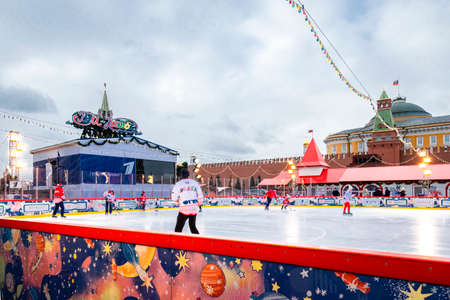 MOSCOW, RUSSIA - FEBRUARY 29, 2020: Happy people play hockey at rink on Red Square in Moscow, Russia