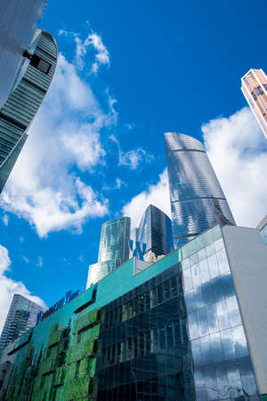 MOSCOW, RUSSIA - FEBRUARY 29, 2020: Skyscrapers modern architecture office building with clouds in blue sky, high tech style of Moscow City, looking up, Moscow, Russiaのeditorial素材