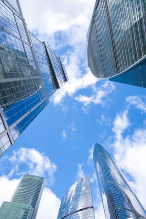 Skyscrapers modern architecture office building with clouds in blue sky, high tech style of Moscow City, looking up, Moscow, Russiaの写真素材